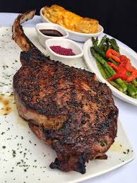Fleming's Prime Steakhouse & Wine Bar signature dishes Prime TomahawkPrime Bone-In RibeyeCreamed Spinach